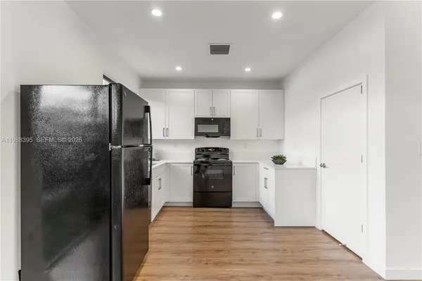 a kitchen with a refrigerator and a sink