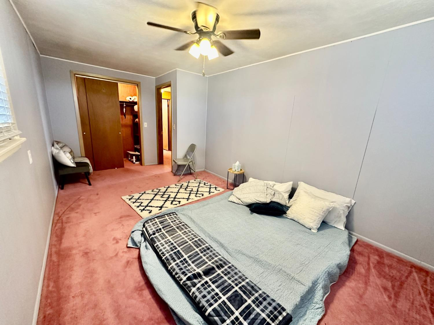 615 Highway 84 Friona, TX 79035 - Photo 19 of 41 a bedroom with a bed and a chandelier