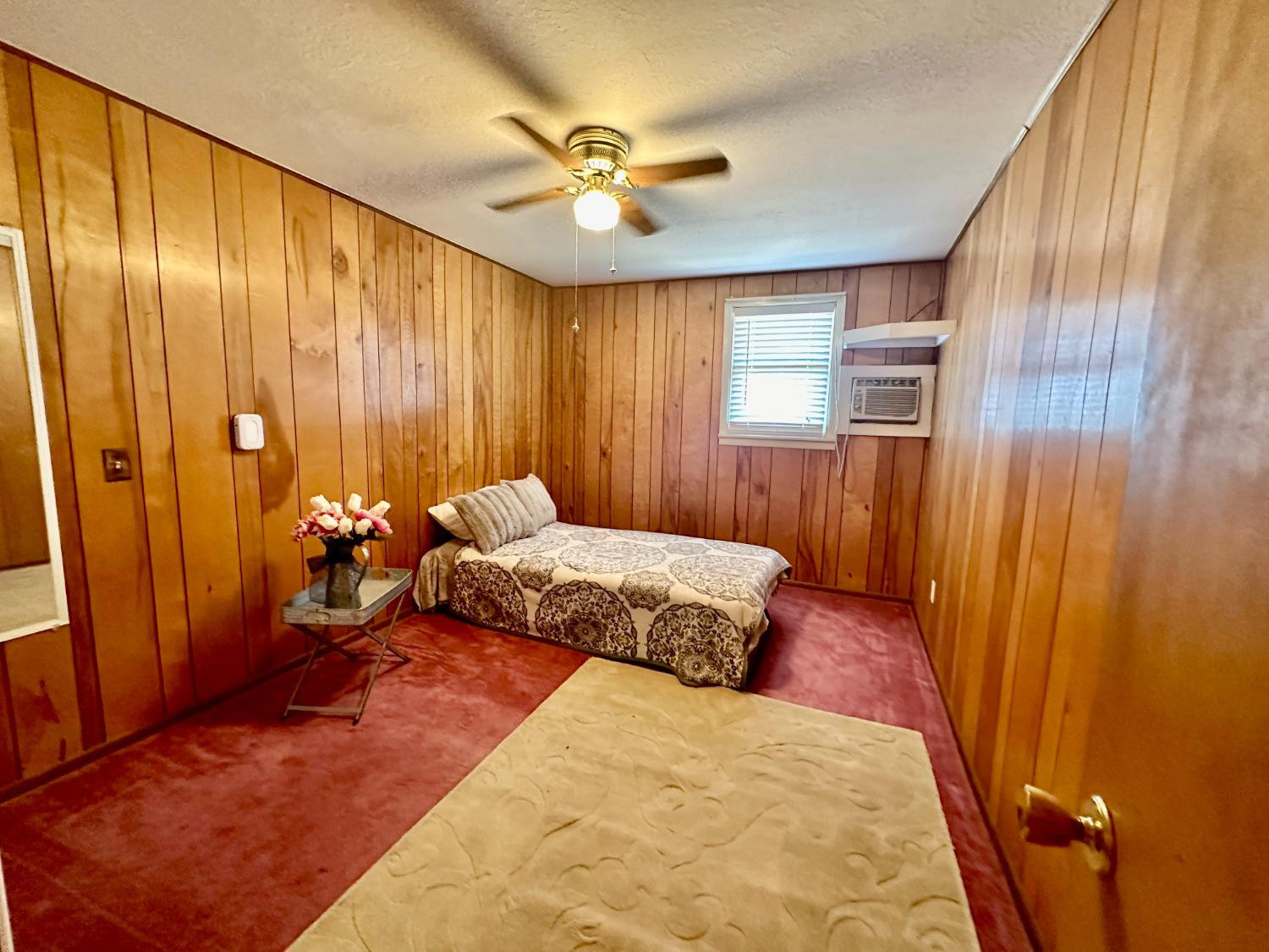 615 Highway 84 Friona, TX 79035 - Photo 24 of 41 a bedroom with a bed and a chandelier