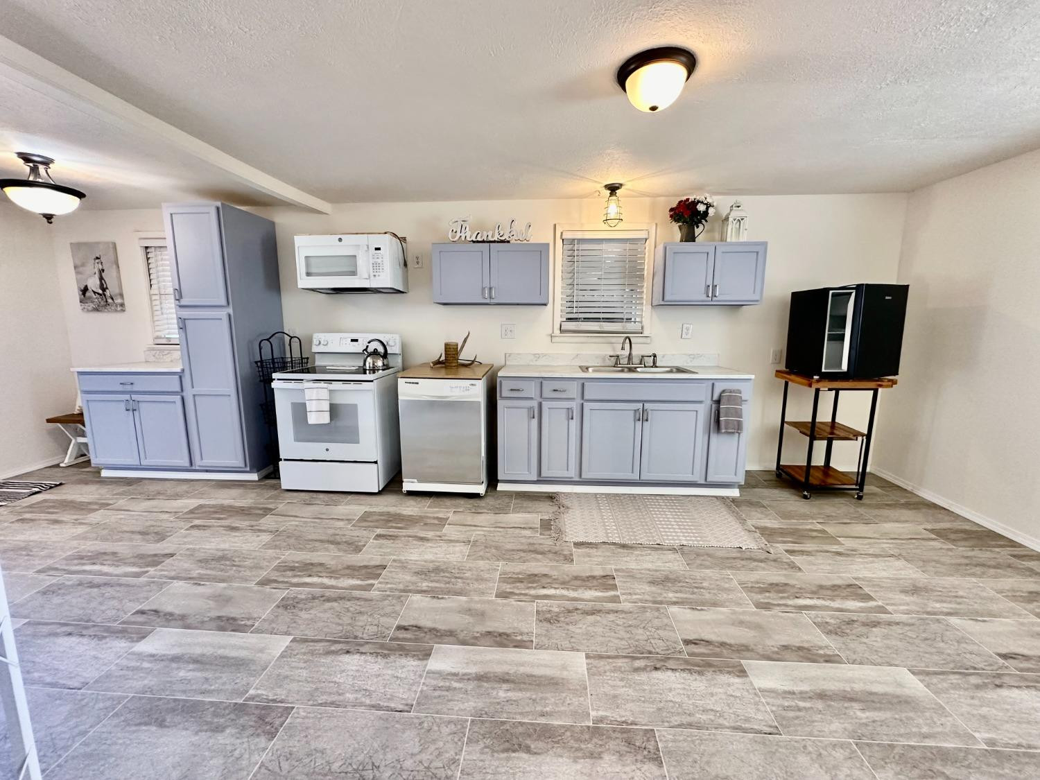 615 Highway 84 Friona, TX 79035 - Photo 6 of 41 a view of kitchen with stainless steel appliances cabinets and wooden floor