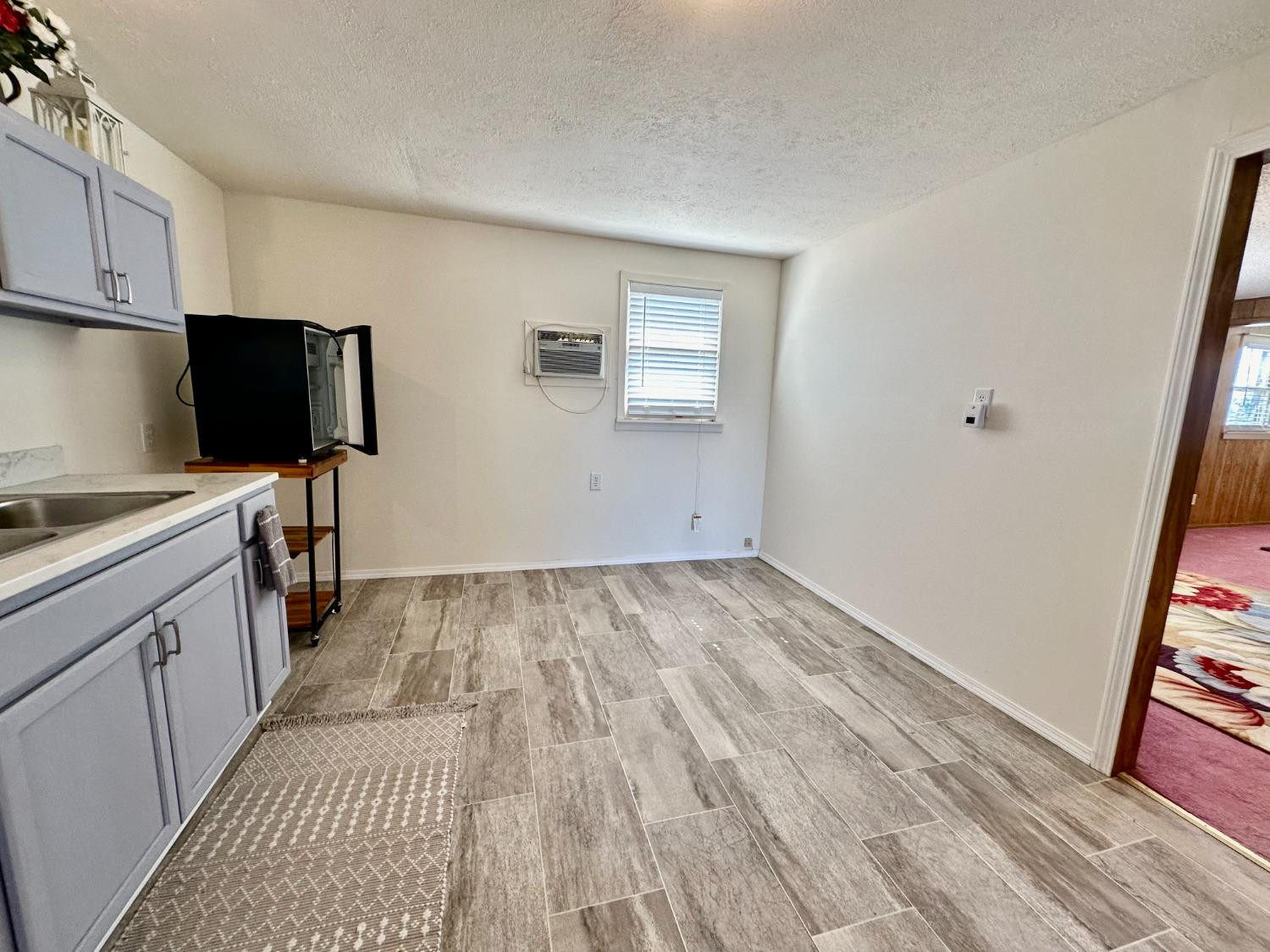 615 Highway 84 Friona, TX 79035 - Photo 10 of 41 a view of a kitchen with wooden floor and furniture
