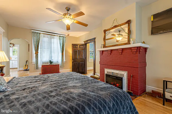 a bedroom with a bed and a fireplace