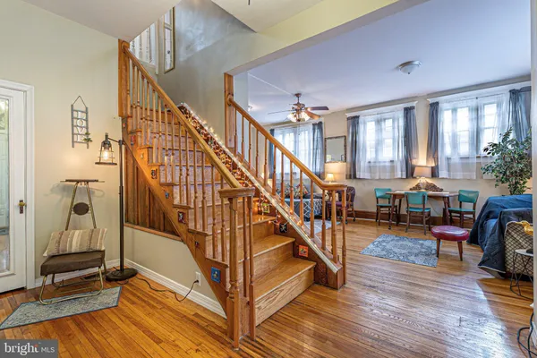 a view of entryway and hall with wooden floor