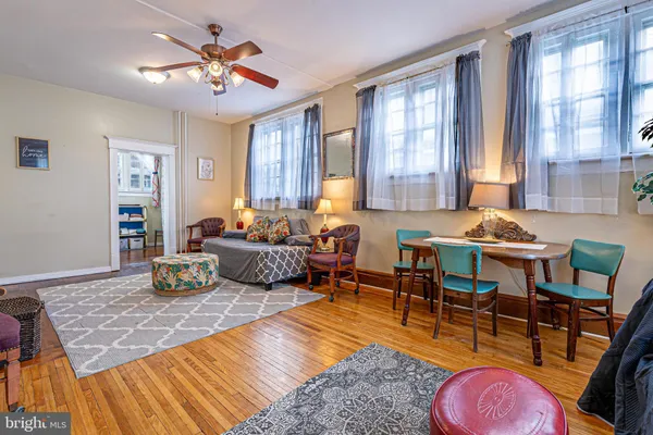 a living room with furniture a rug and a window