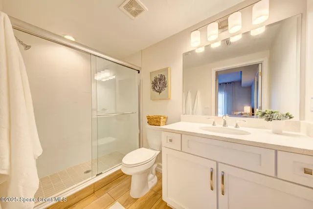 a bathroom with a sink and a mirror with toilet