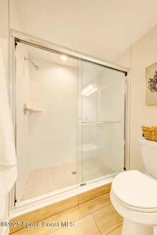 a bathroom with a shower and a toilet