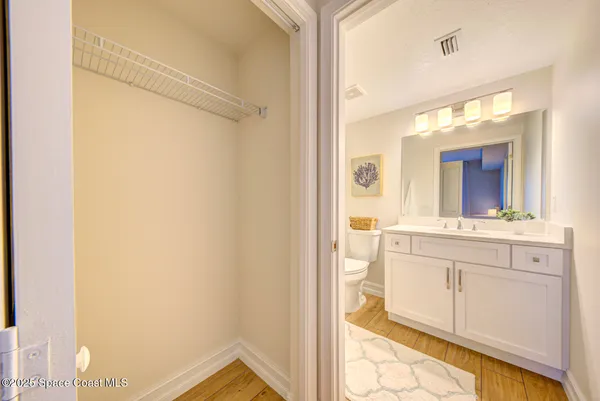 a bathroom with a sink mirror and a shower