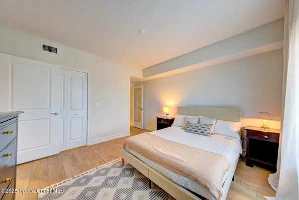 a bedroom with a bed and a lamp