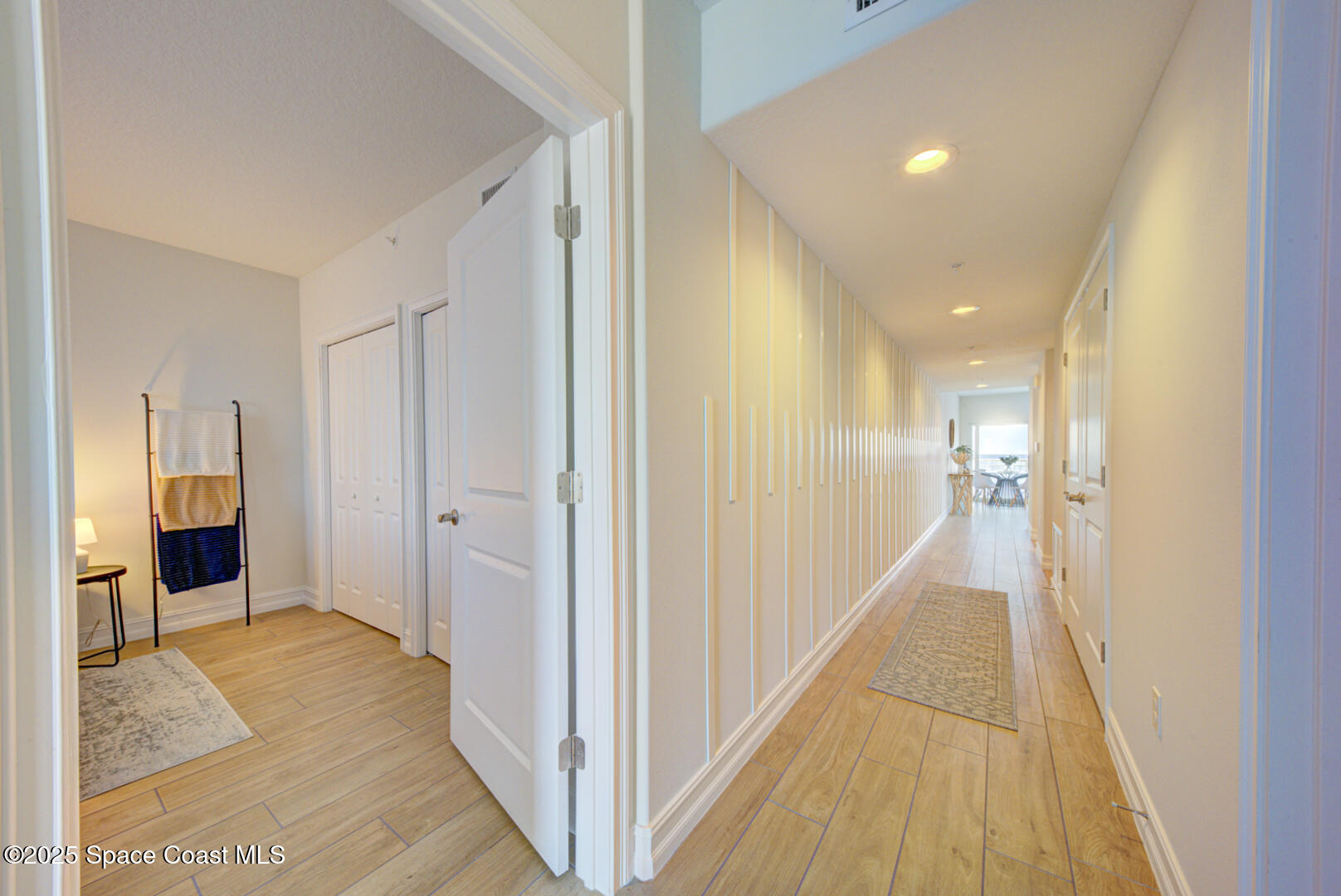 1805 Riverside Drive, Unit 504 Titusville, FL 32780 - Photo 16 of 48 a view of a hallway with wooden floor and a bathroom