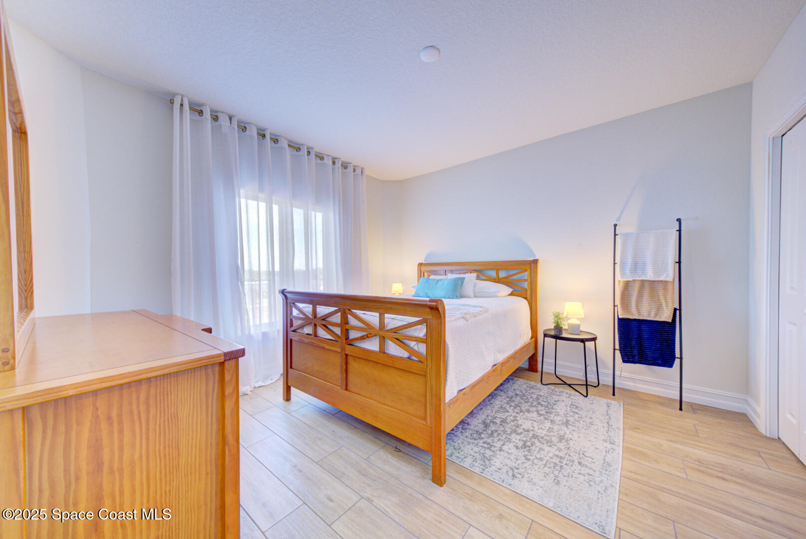 1805 Riverside Drive, Unit 504 Titusville, FL 32780 - Photo 17 of 48 a bedroom with a bed and a table in it