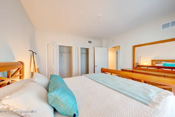 a bedroom with a bed and a view of living room