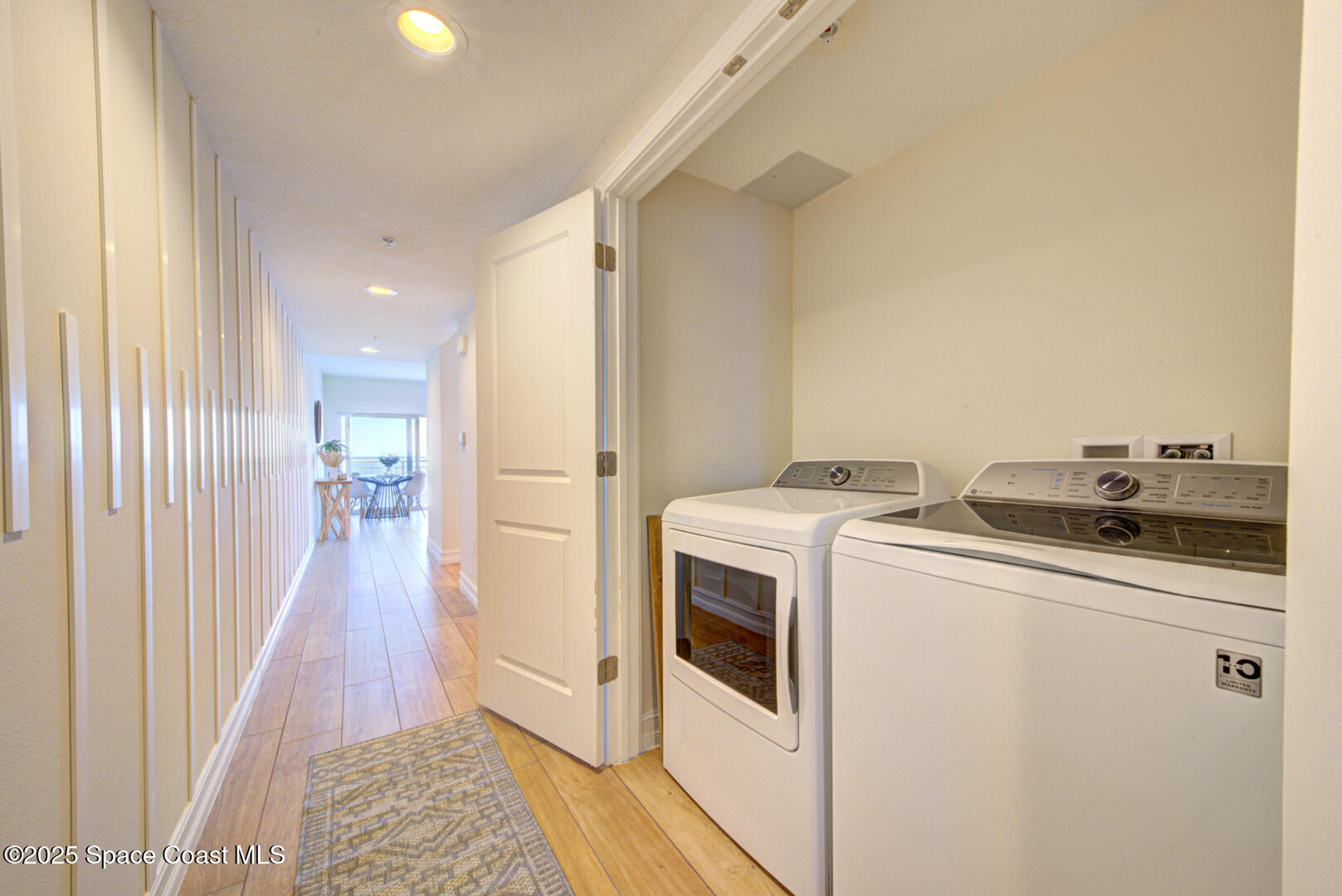 1805 Riverside Drive, Unit 504 Titusville, FL 32780 - Photo 21 of 48 a view of washer and dryer with kitchen in the background