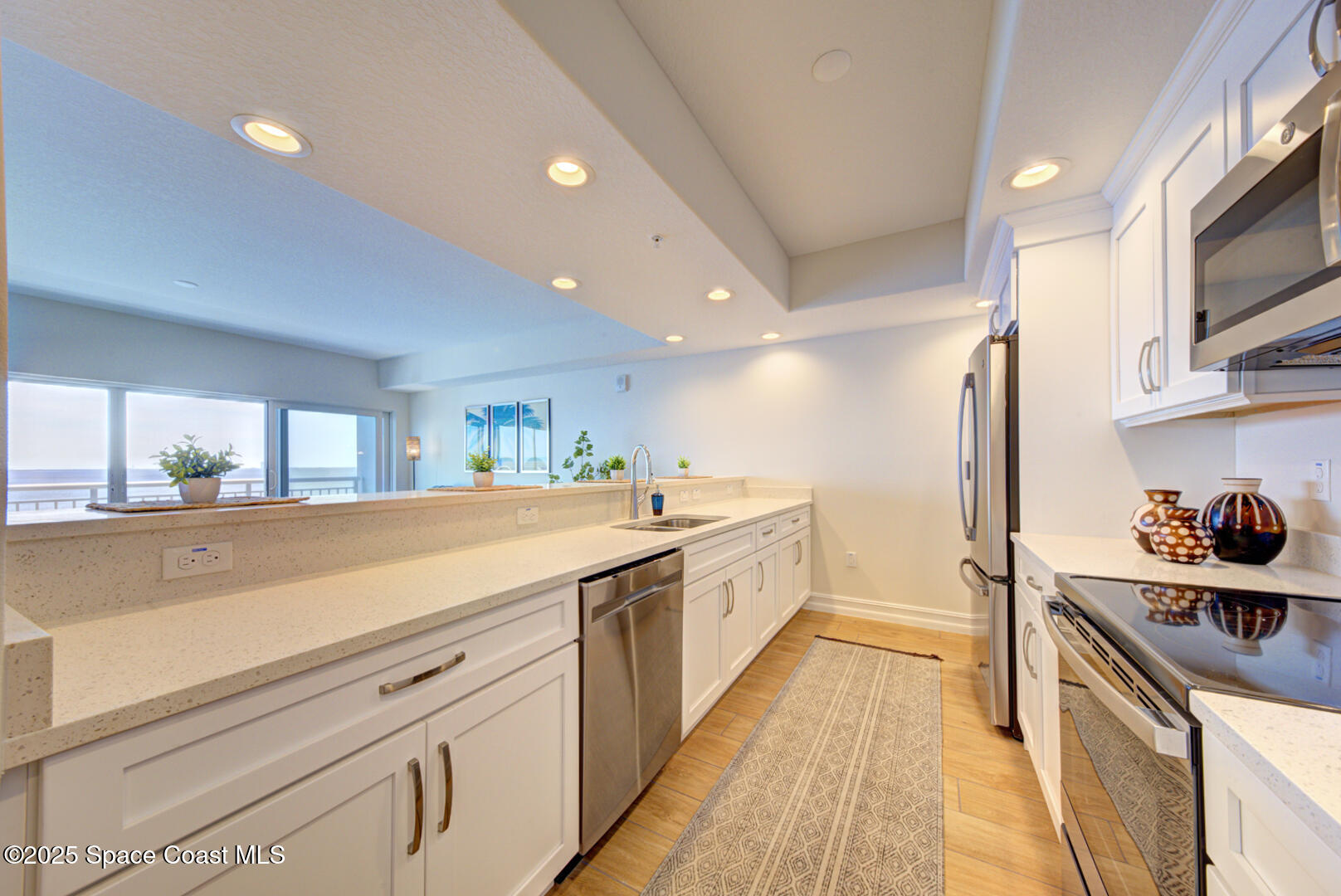 1805 Riverside Drive, Unit 504 Titusville, FL 32780 - Photo 23 of 48 a kitchen with a sink and cabinets