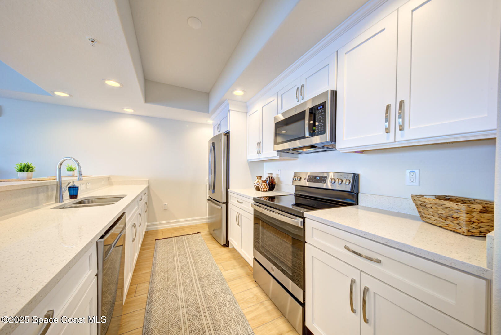 1805 Riverside Drive, Unit 504 Titusville, FL 32780 - Photo 26 of 48 a kitchen with stainless steel appliances granite countertop a sink and cabinets