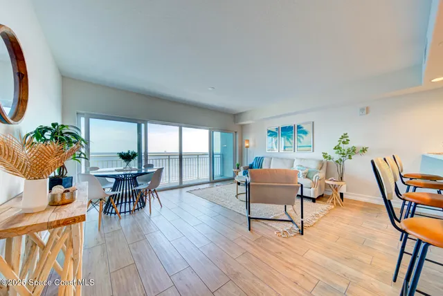 a living room with furniture a table and wooden floor