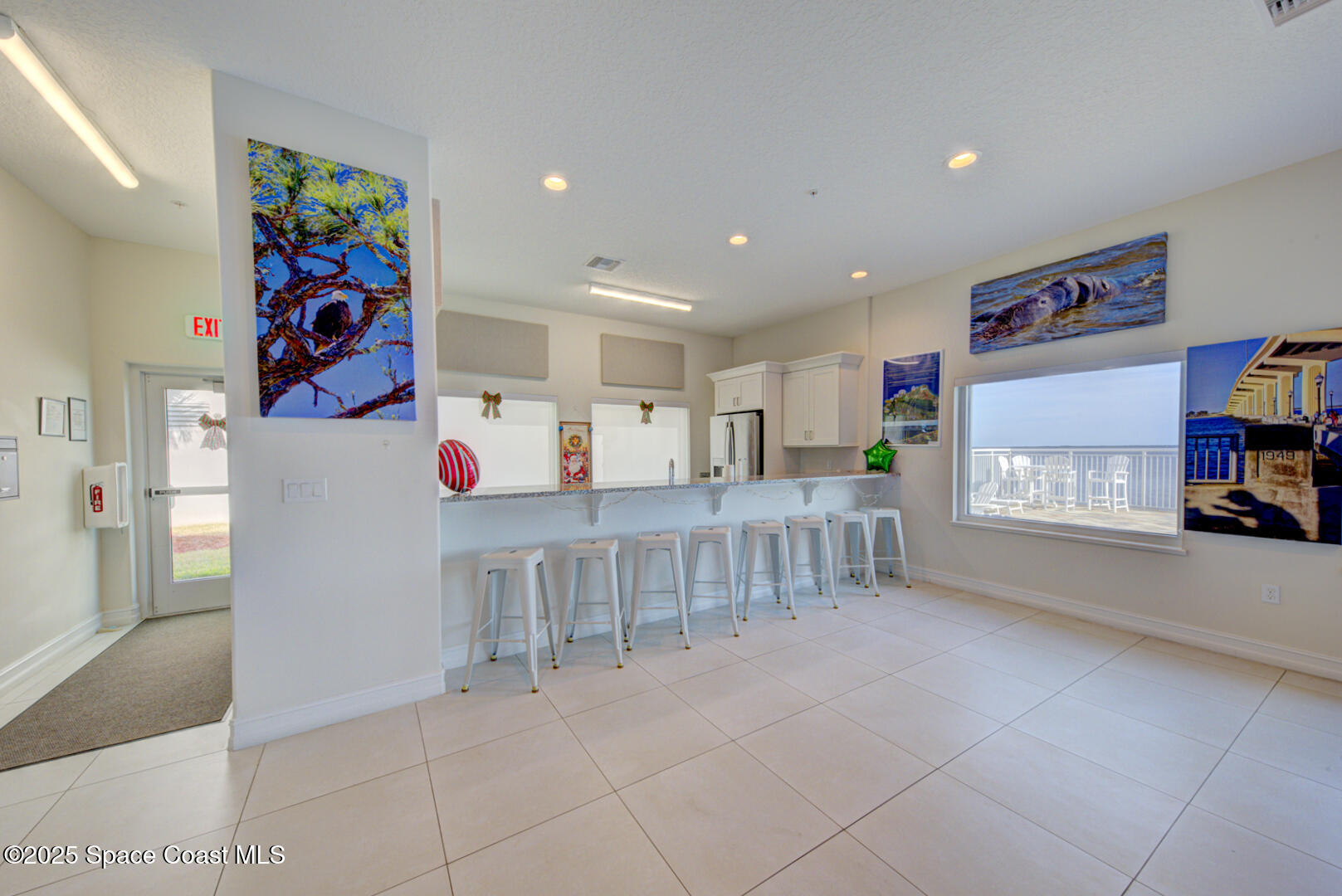 1805 Riverside Drive, Unit 504 Titusville, FL 32780 - Photo 46 of 48 a living room with furniture and a book shelf