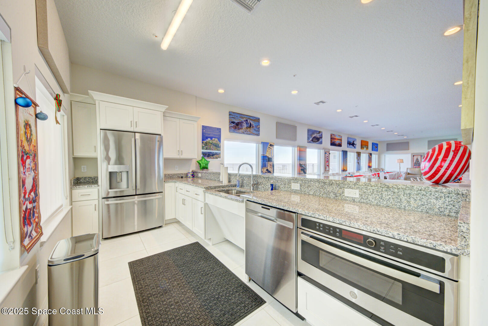 1805 Riverside Drive, Unit 504 Titusville, FL 32780 - Photo 47 of 48 a kitchen with stainless steel appliances granite countertop a refrigerator and a sink