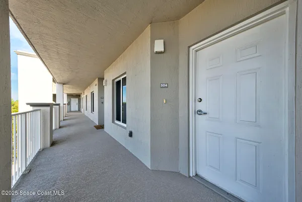 a view of a hallway with wooden shelves