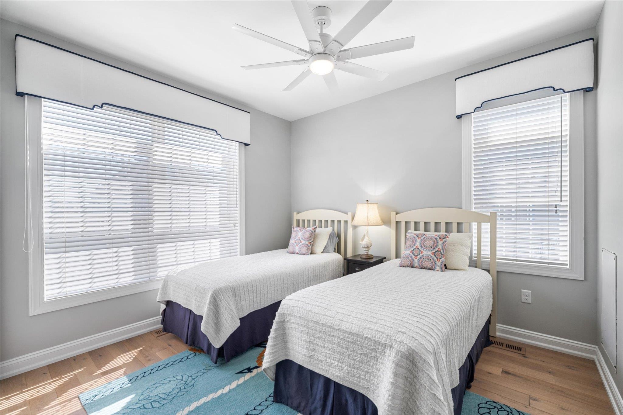 a bedroom with two beds and a window