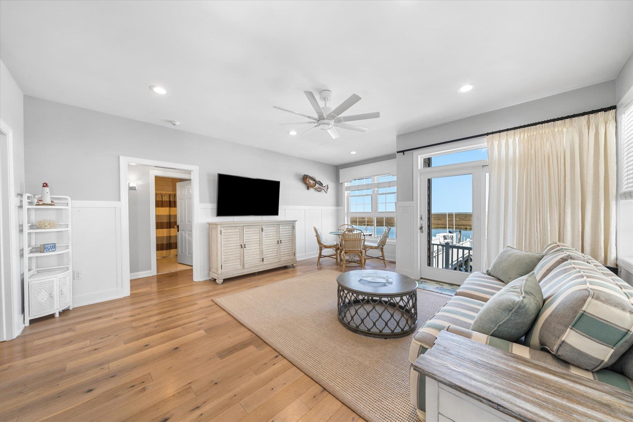 11 Leonard's Lane Avalon, NJ 08202 - Photo 22 of 34 a spacious bedroom with a bed large window and a flat screen television