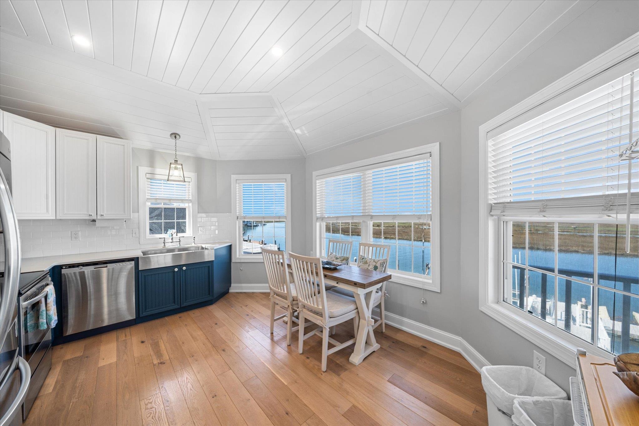 11 Leonard's Lane Avalon, NJ 08202 - Photo 5 of 34 a kitchen with granite countertop a dining table chairs and wooden floor