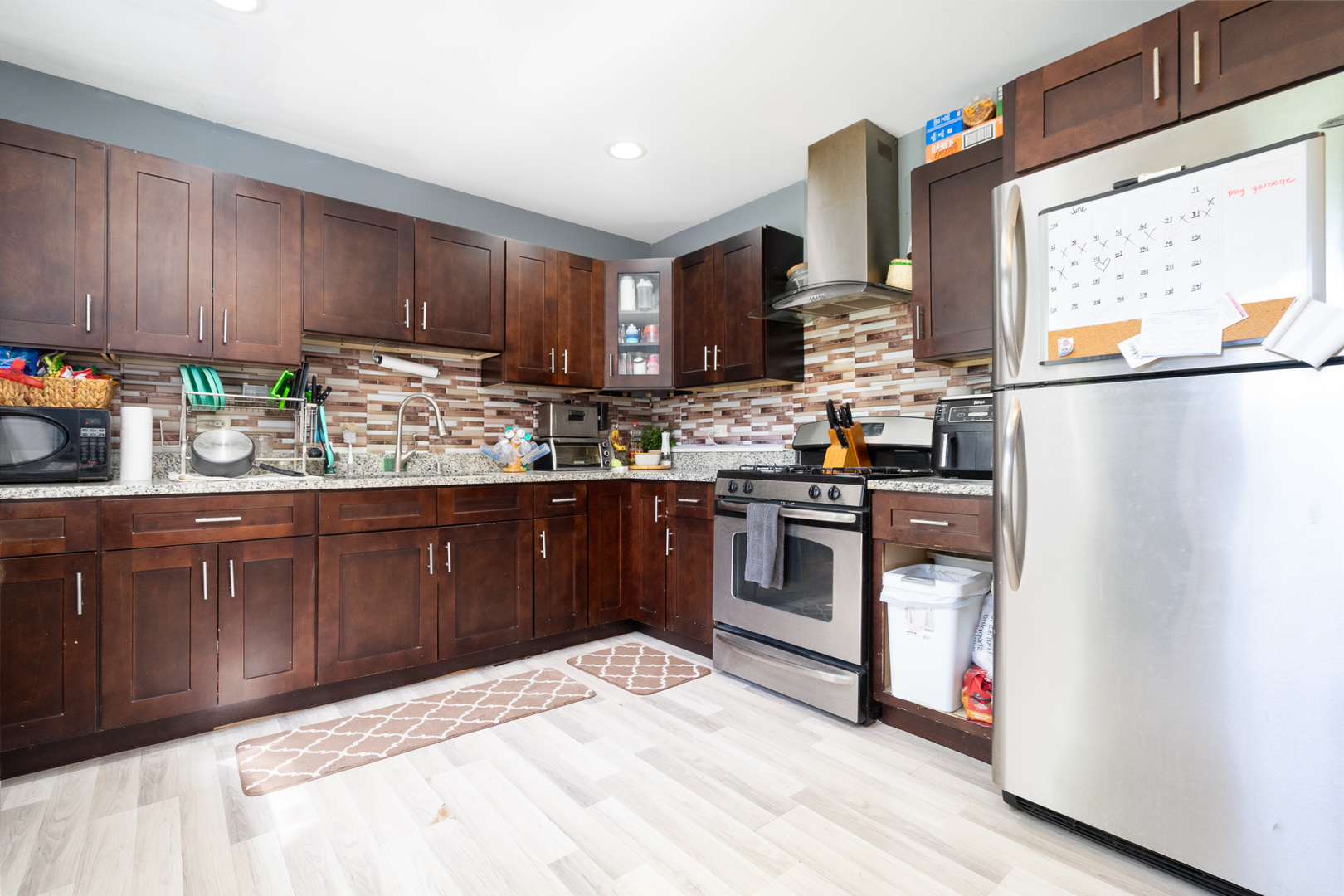 132 Edison Road Joliet, IL 60433 - Photo 5 of 18 a kitchen with stainless steel appliances granite countertop a refrigerator sink and cabinets