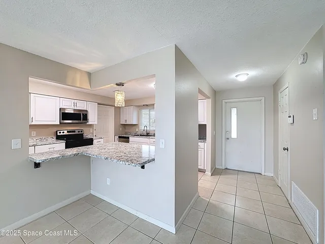a view of a hallway to rooms