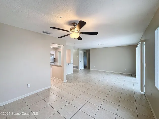a view of a house with a big yard and large trees