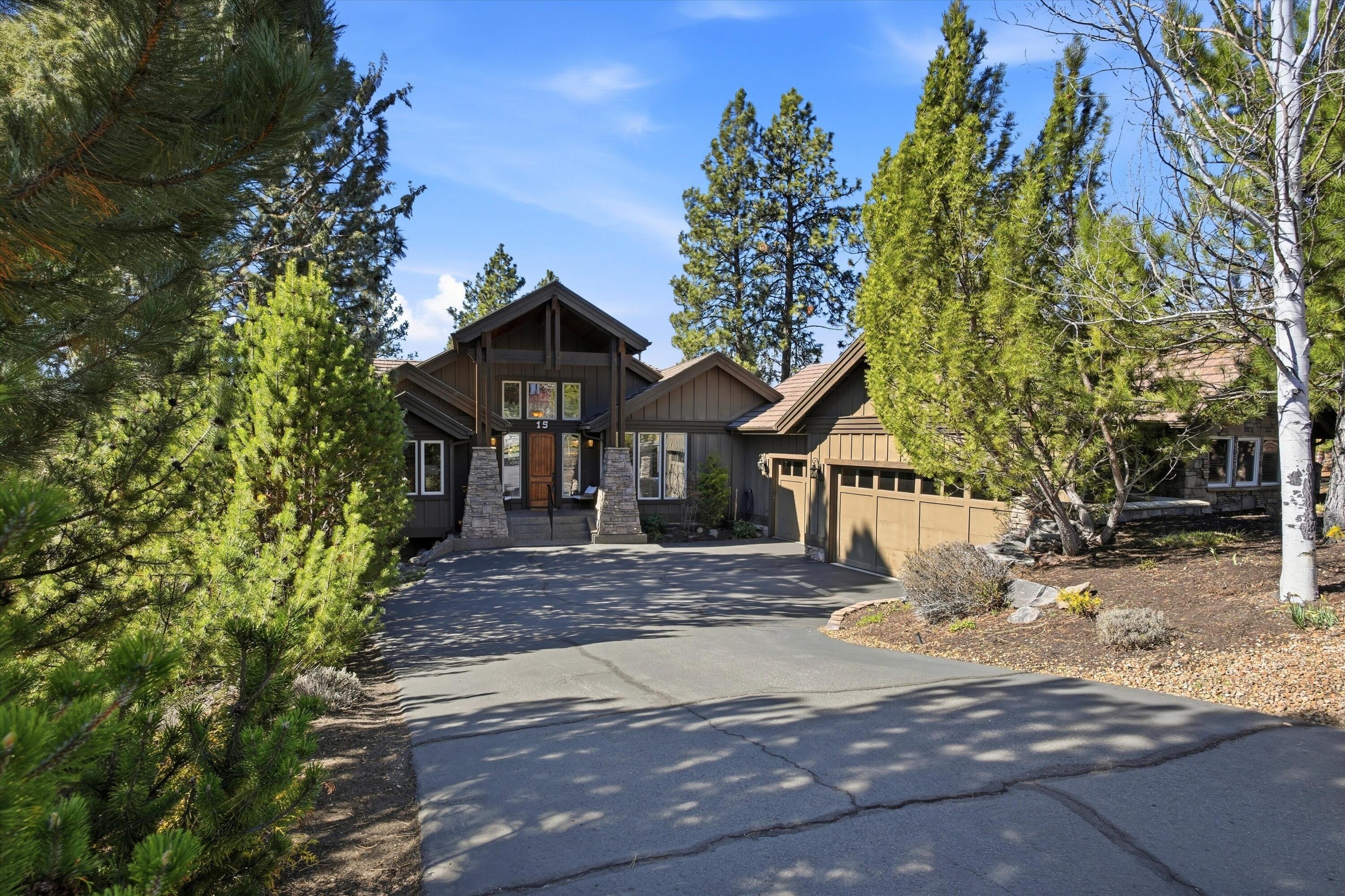 15 Southwest Quail Butte Place Bend, OR 97703 - Photo 5 of 55 a front view of a house with a yard