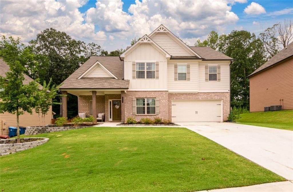 3370 Elkhorn Ridge Run Dacula, GA 30019 - Photo 1 of 29 a front view of a house with a yard and trees