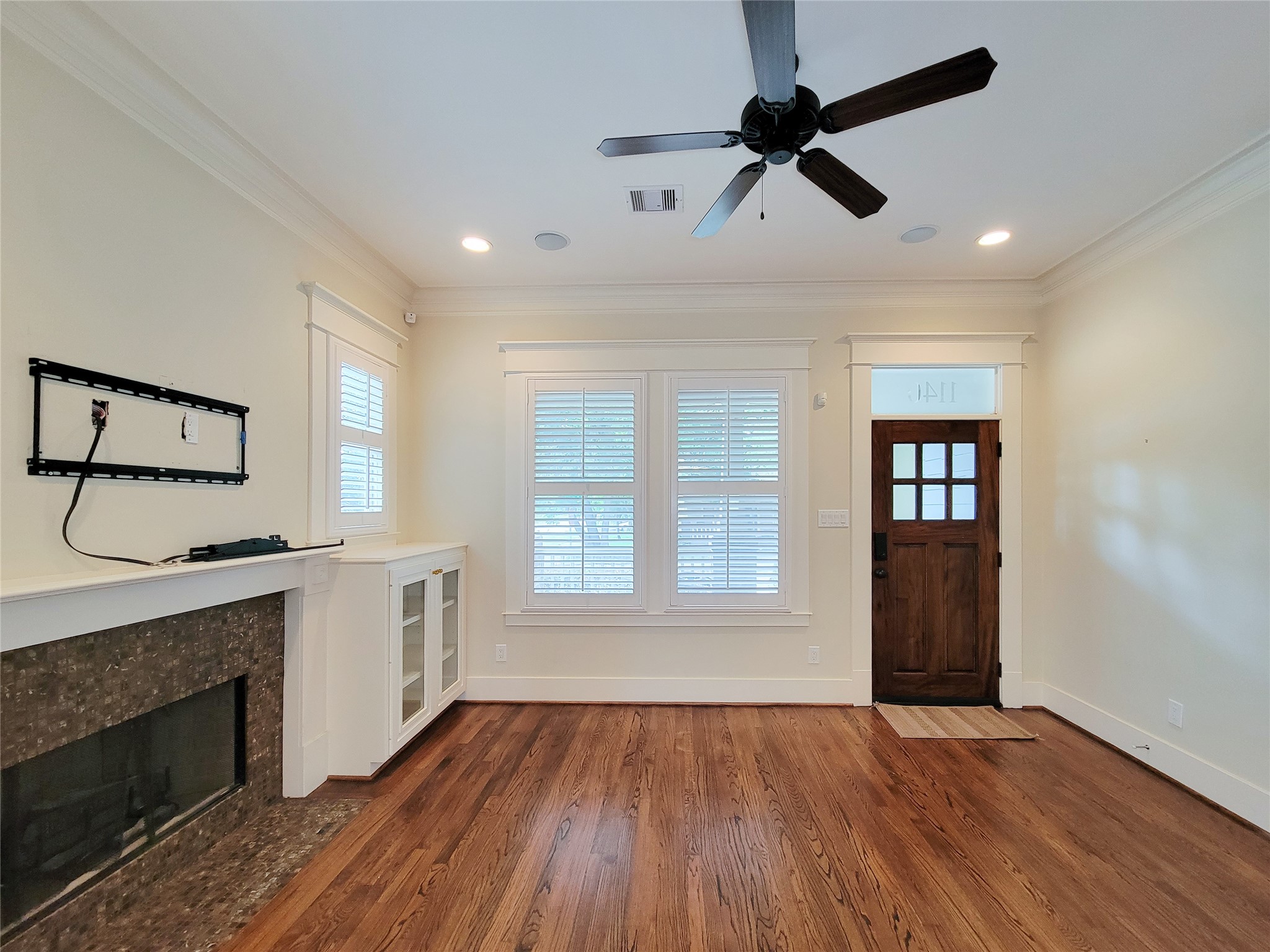 1140 West Cottage Street Houston, TX 77009 - Photo 5 of 37 a view of an empty room with a kitchen and wooden floor