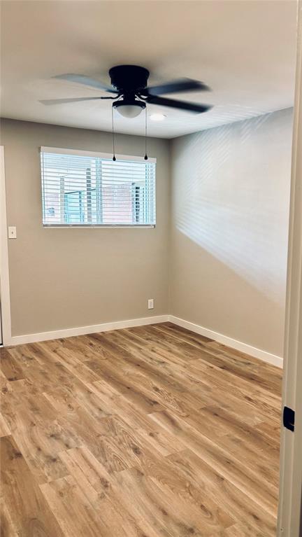 4603 Junius Street, Unit 8 Dallas, TX 75246 - Photo 12 of 16 Bedroom featuring a ceiling fan and light wood-style floors