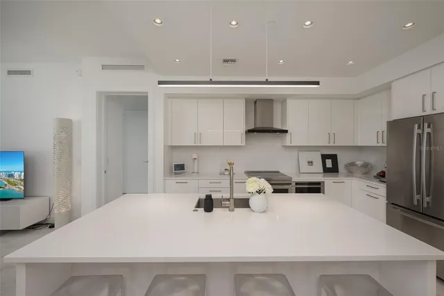 a kitchen with a sink appliances and cabinets