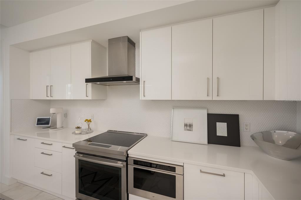 111 South Pineapple Avenue, Unit 1013 Sarasota, FL 34236 - Photo 12 of 62 a kitchen with cabinets appliances and a sink