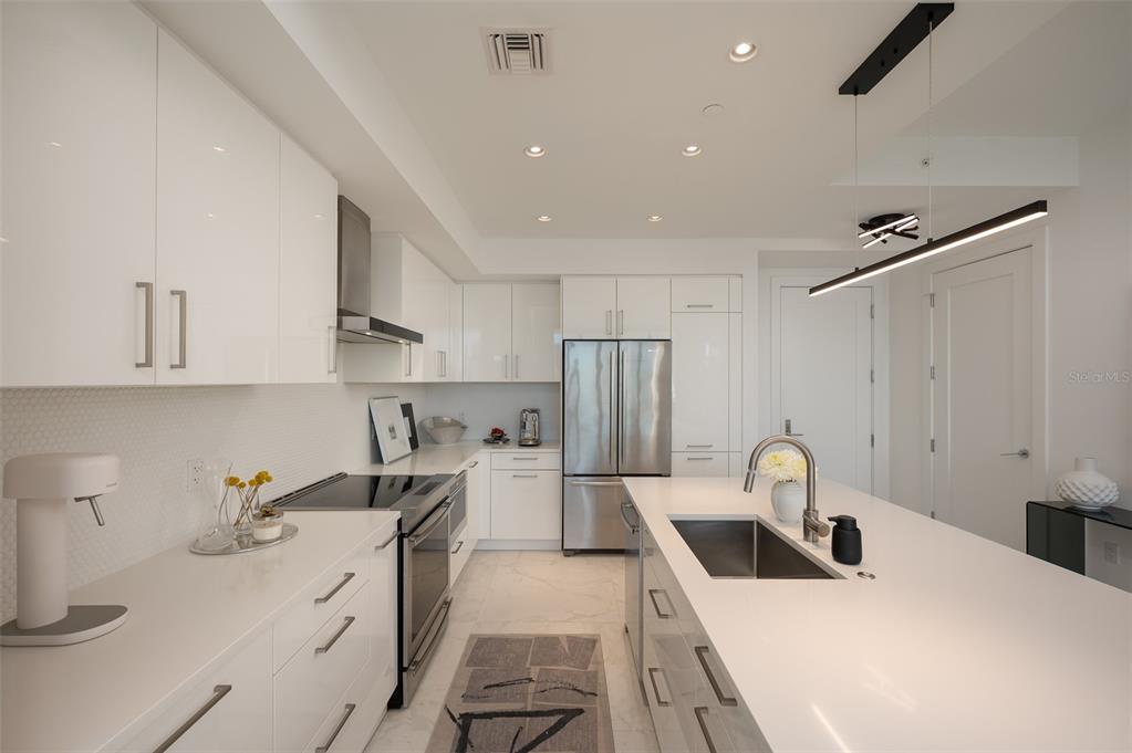 111 South Pineapple Avenue, Unit 1013 Sarasota, FL 34236 - Photo 13 of 62 a kitchen with a sink appliances and cabinets