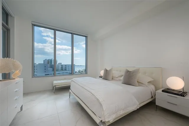 a bedroom with bed and a chandelier