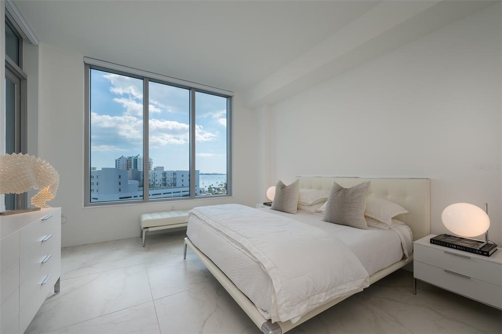 111 South Pineapple Avenue, Unit 1013 Sarasota, FL 34236 - Photo 16 of 62 a bedroom with a bed and a large window