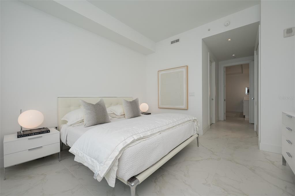 111 South Pineapple Avenue, Unit 1013 Sarasota, FL 34236 - Photo 18 of 62 a bedroom with bed and a chandelier