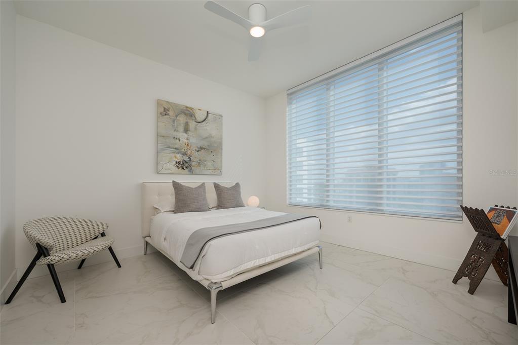 111 South Pineapple Avenue, Unit 1013 Sarasota, FL 34236 - Photo 23 of 62 a spacious bedroom with a bed and a chair