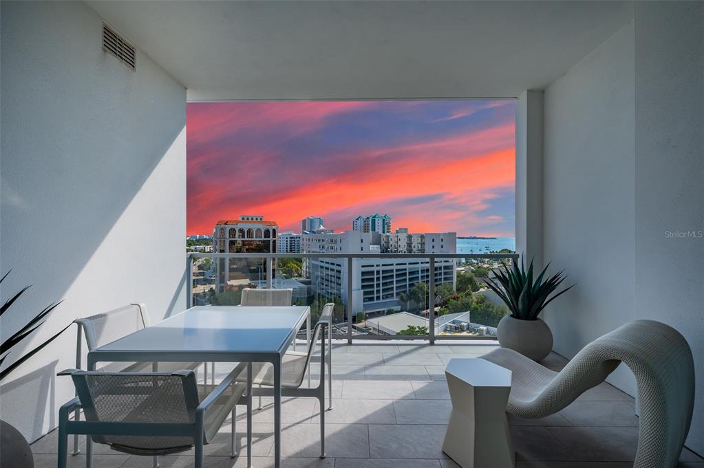 111 South Pineapple Avenue, Unit 1013 Sarasota, FL 34236 - Photo 30 of 62 a view of a dining room with furniture and wooden floor