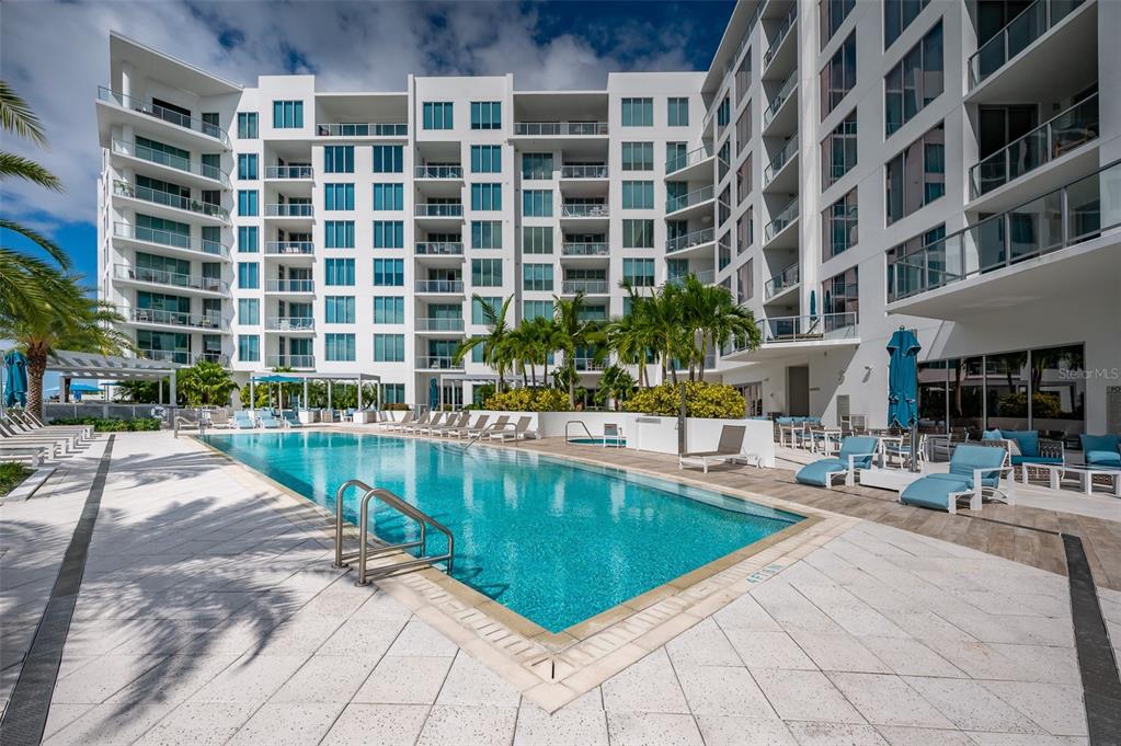 111 South Pineapple Avenue, Unit 1013 Sarasota, FL 34236 - Photo 33 of 62 a swimming pool with outdoor seating and yard