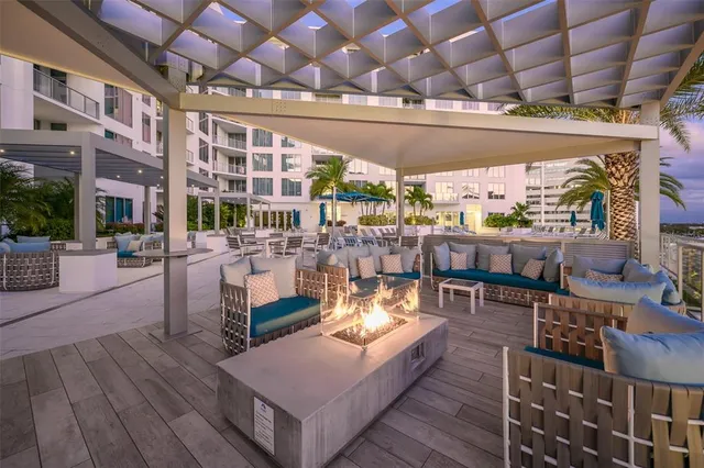 a living room with furniture potted plant and a flat screen tv