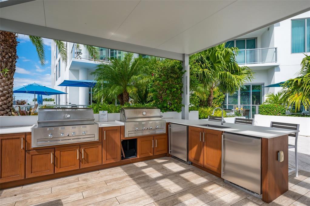 111 South Pineapple Avenue, Unit 1013 Sarasota, FL 34236 - Photo 40 of 62 a kitchen with stainless steel appliances granite countertop a stove and a sink