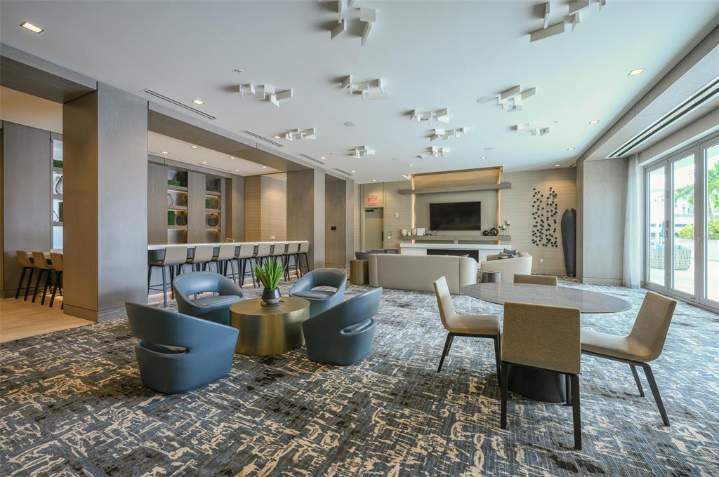 111 South Pineapple Avenue, Unit 1013 Sarasota, FL 34236 - Photo 47 of 62 a living room with furniture potted plant and a flat screen tv