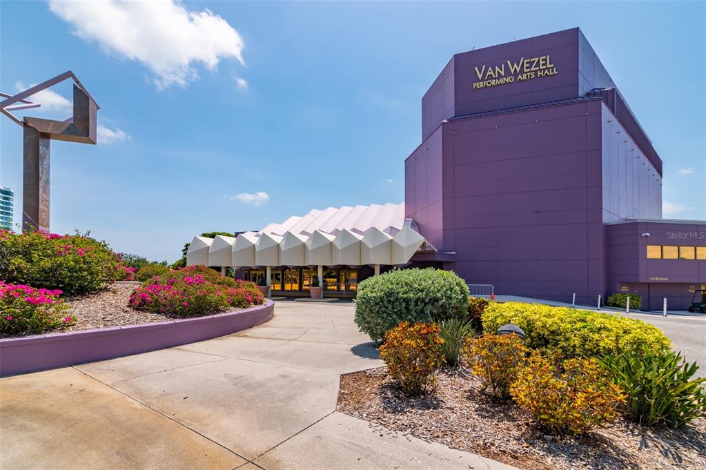 111 South Pineapple Avenue, Unit 1013 Sarasota, FL 34236 - Photo 58 of 62 a front view of a house with a yard and lots of potted plants