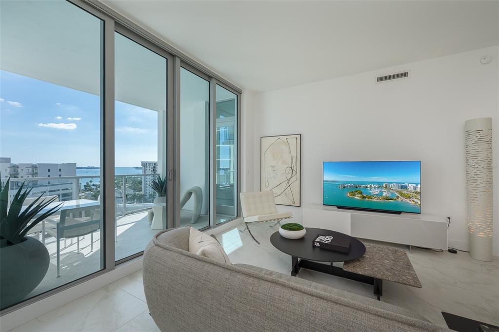 111 South Pineapple Avenue, Unit 1013 Sarasota, FL 34236 - Photo 6 of 62 a living room with furniture floor to ceiling window and floor to ceiling window