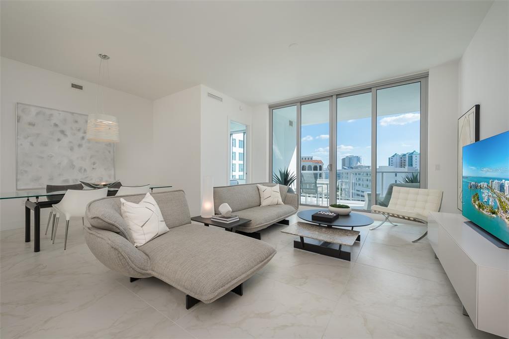 111 South Pineapple Avenue, Unit 1013 Sarasota, FL 34236 - Photo 8 of 62 a living room with furniture and a large window with balcony view