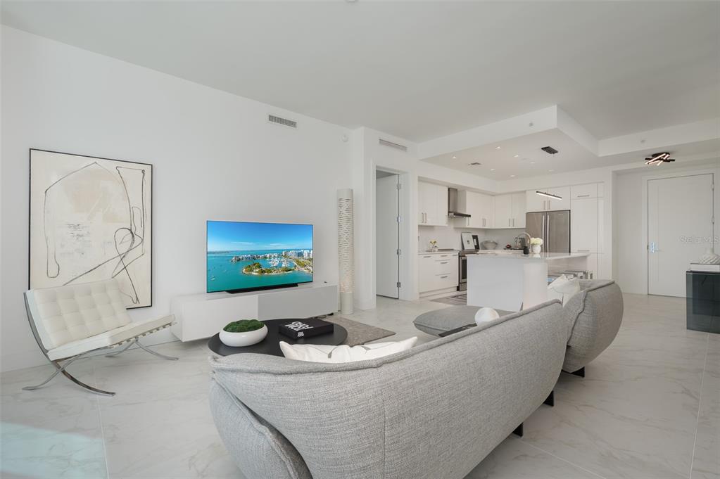 111 South Pineapple Avenue, Unit 1013 Sarasota, FL 34236 - Photo 9 of 62 a living room with furniture and a flat screen tv