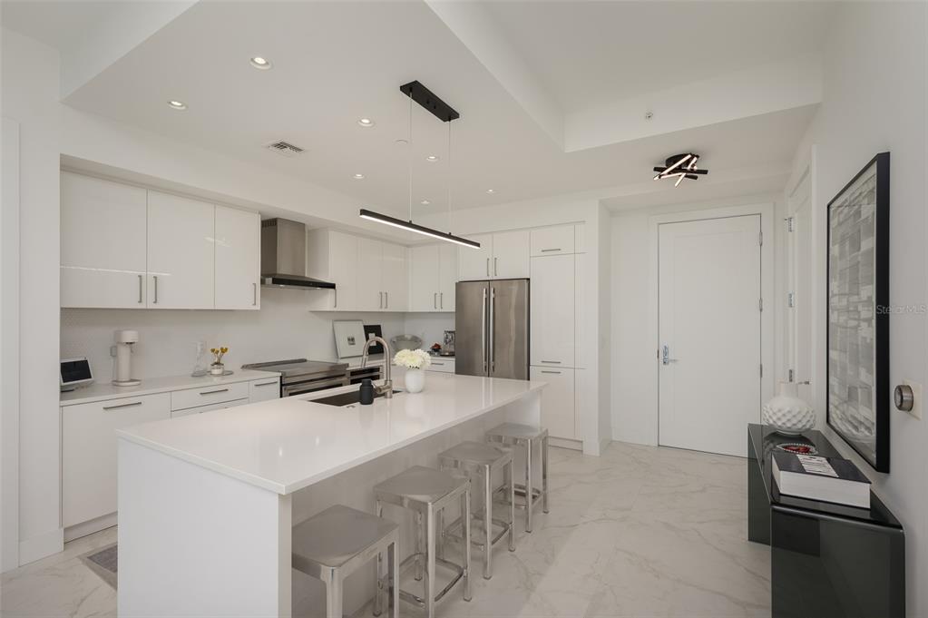 111 South Pineapple Avenue, Unit 1013 Sarasota, FL 34236 - Photo 10 of 62 a kitchen with stainless steel appliances a sink stove and refrigerator