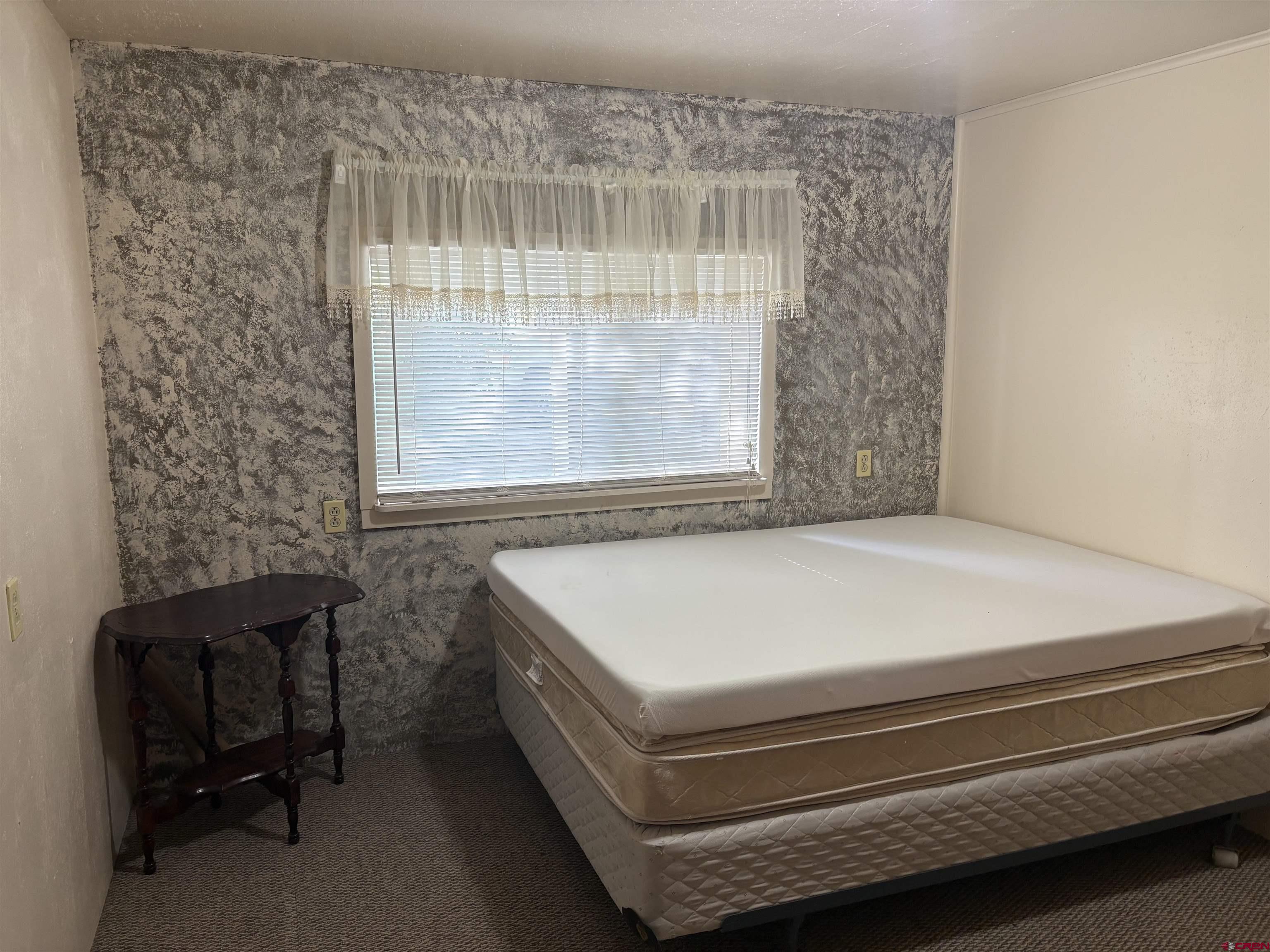 20806 County Road West Sanford, CO 81151 - Photo 14 of 24 a bedroom with a bed and a window